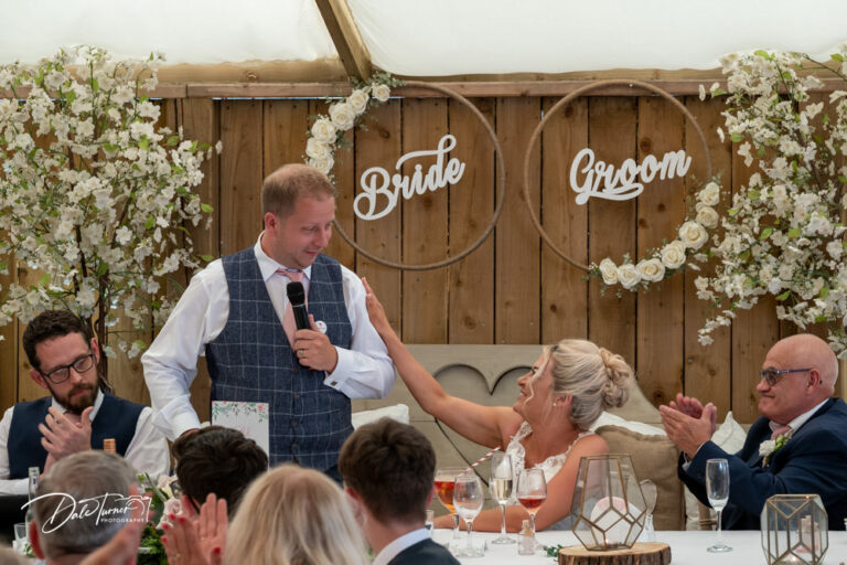 Groom delivering his speech while the bride holds his arm. At Loversall Farm, Tickhill.