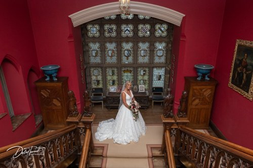 Bride standing at the top of the main staircase inside Carlton Towers.