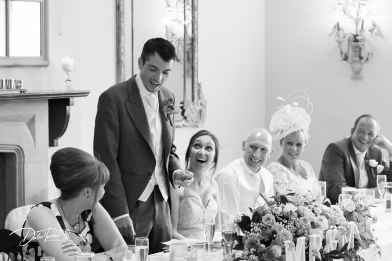Groom giving his speech while the bride and her parents look at him laughing. At The Tickton Grange.