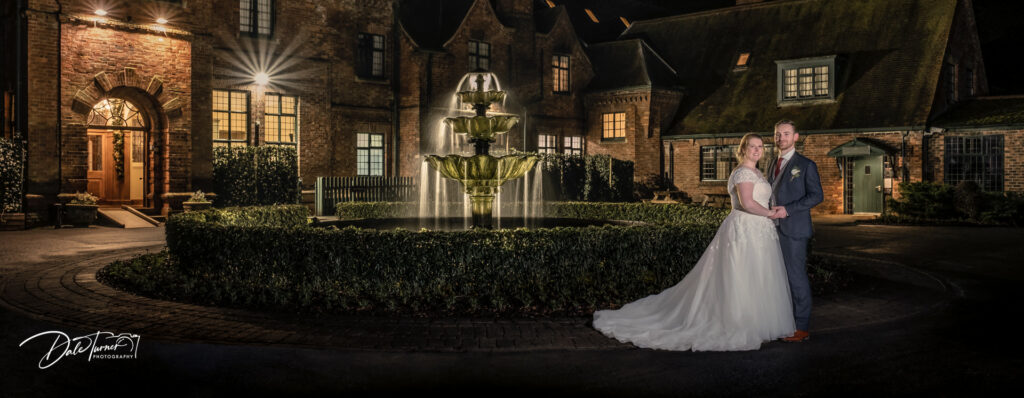 Twilight image of bride and groom outside Aldwark Manor.