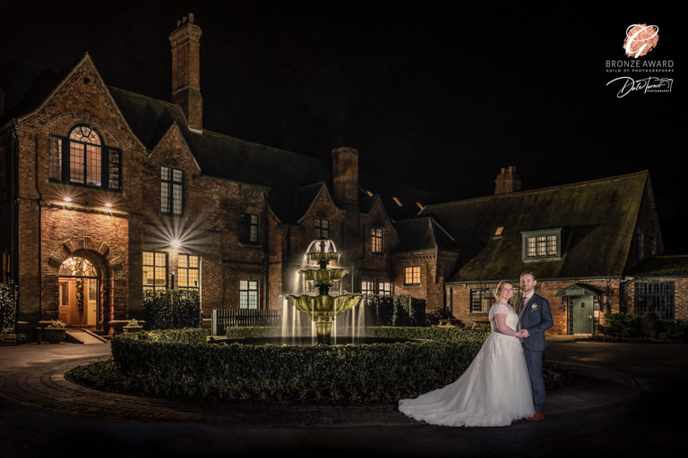 Award winning image of bride and groom outside Aldwark Manor.
