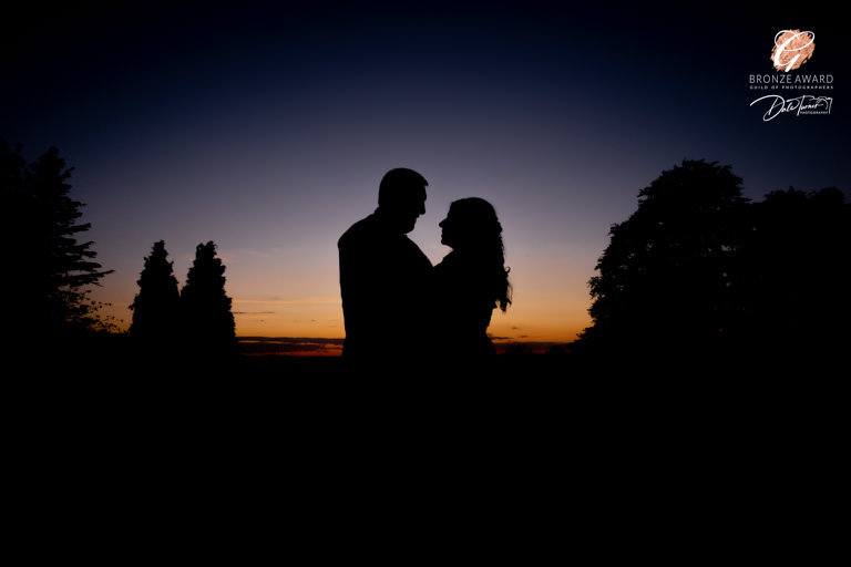 Award winning image of a bride and groom in silhouette against a sunset.