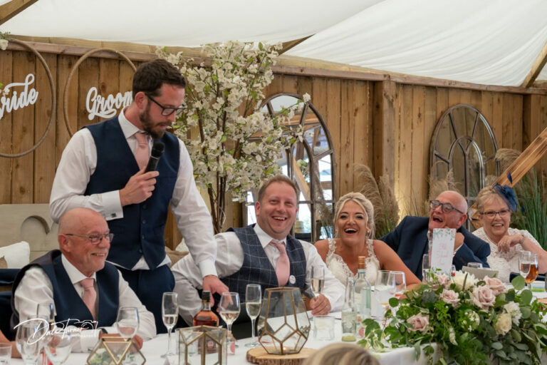 Best Man delivering his speech and everyone on the Top Table is laughing. Loversall Farm, Tickhill.