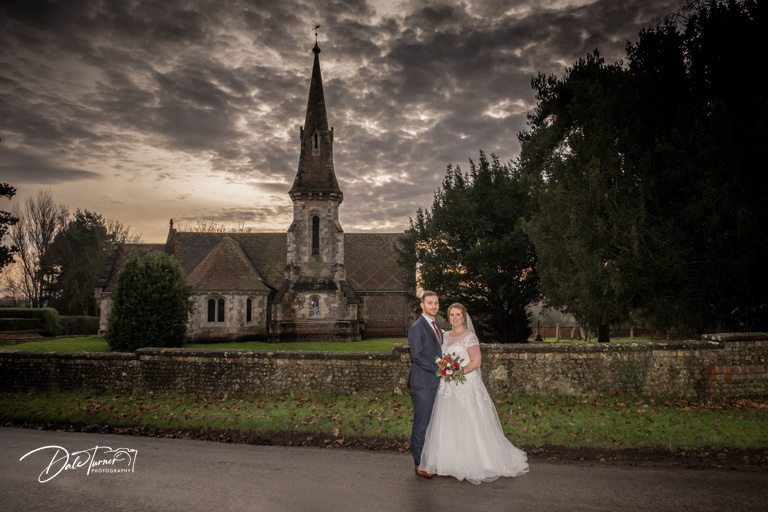 Bride and groom with St. Stephens Church in Aldwark with dramatic sky.