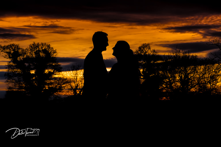 Bride and groom silhouette with sunset.