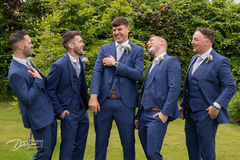 Groom laughing with his ushers.