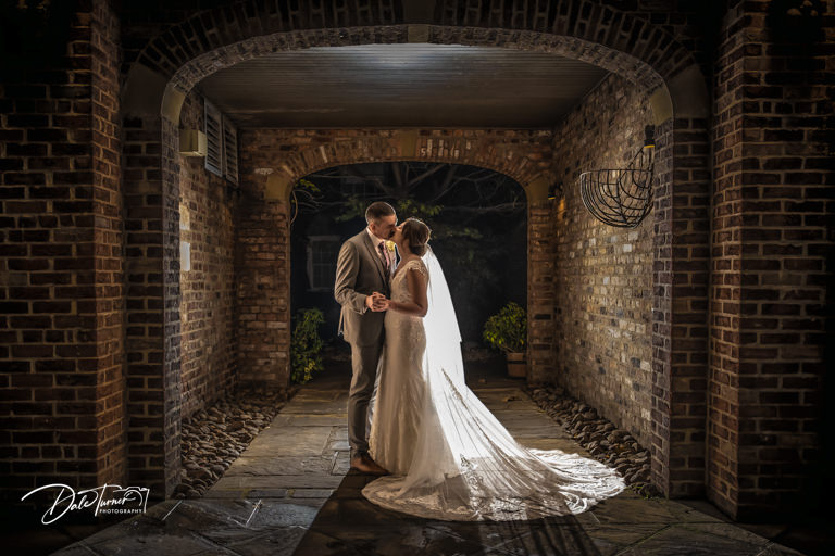 Bride and groom kissing, twilight wedding photography at The York Pavilion Hotel.