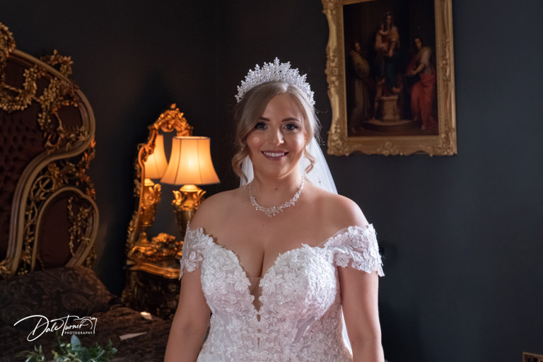 Bride in the bridal suite of Allerton Castle.