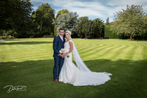 Bride and groom in the grounds of Hazlewood Castle.