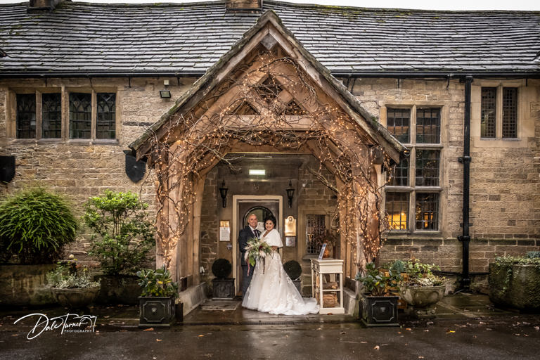 Bride and groom at the main entrance of Whitley Hall.