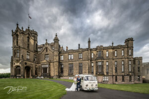 Bride and groom with a VW Camper with Allerton Castle in the background.