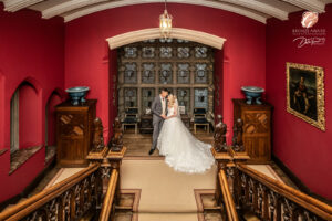 Award winning photograph of a bride and groom holding hands on the staircase inside Carlton Towers.