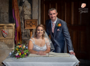 Award winning photograph of a bride and groom just after they have signed the marriage certificate.