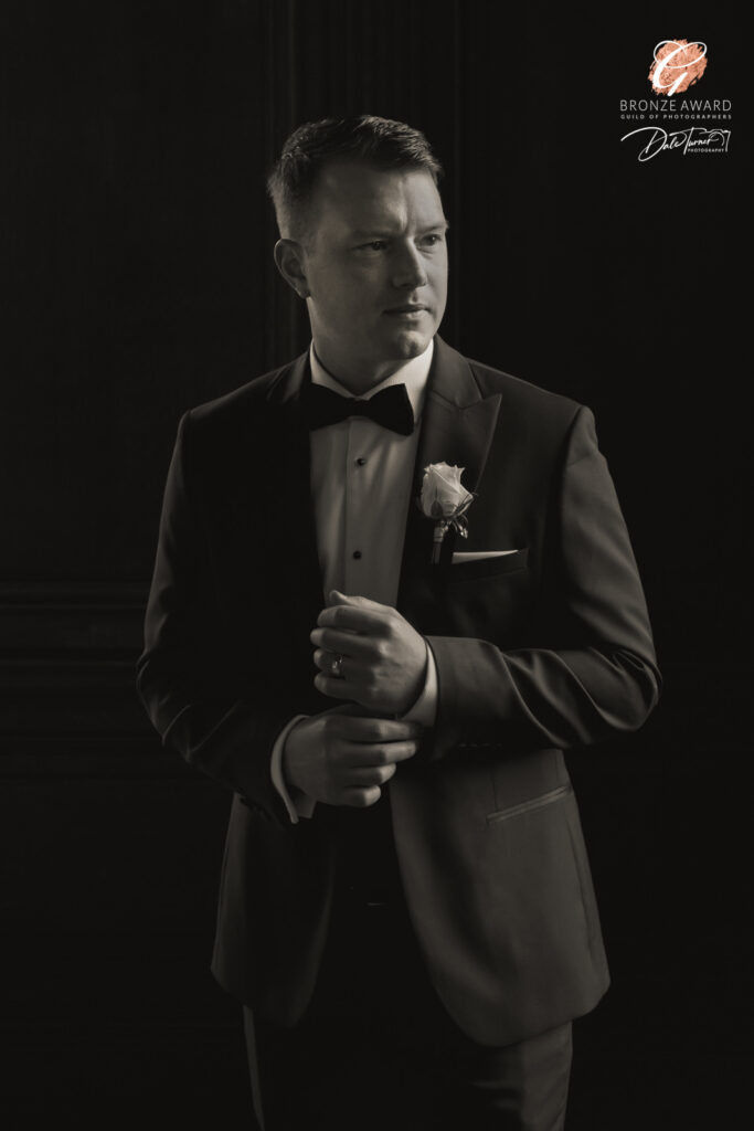 Award winning photograph of a groom while he adjusts his cufflinks, at The Principal, York.