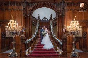 Award winning photograph of a bride and groom standing on the main staircase inside Allerton Castle.