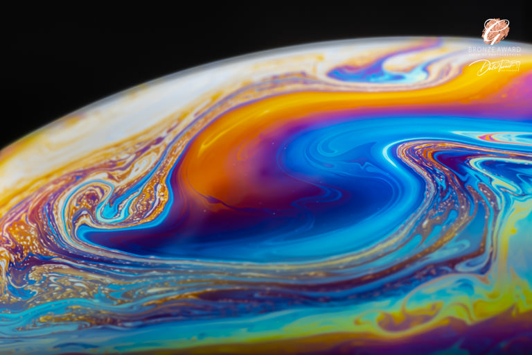 Award winning image of a bubble with multicoloured swirls.