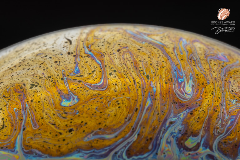 Award winning image of a bubble that has golden swirls.