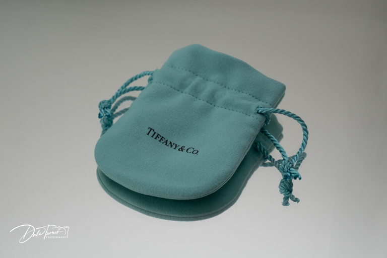 Tiffany & Co branded blue jewellery pouch on a reflected background.