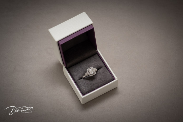 Diamond engagement ring in open velvet box.