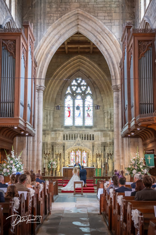 Wedding ceremony in a grand church interior.