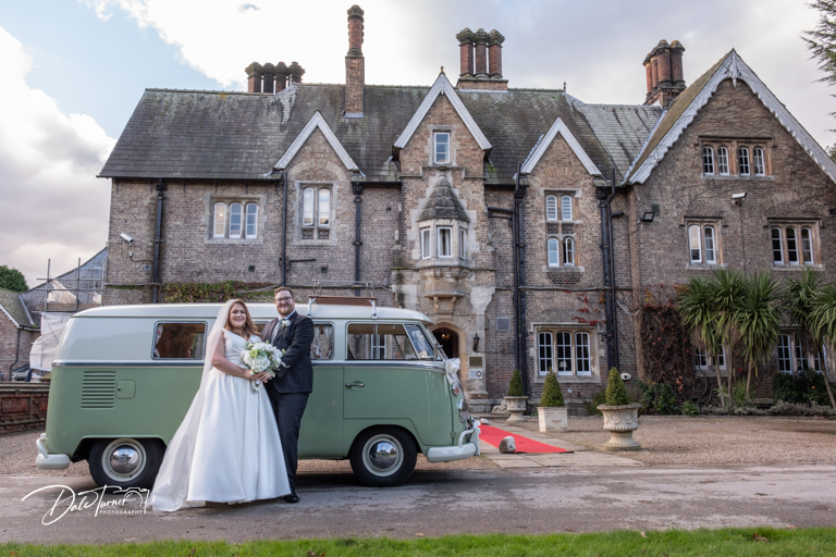 Couple with a vintage VW Camper van outside The Parsonage.