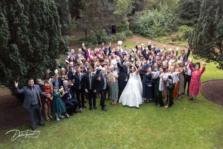 Drone image of wedding guests gathered in garden celebration at The Parsonage Hotel.