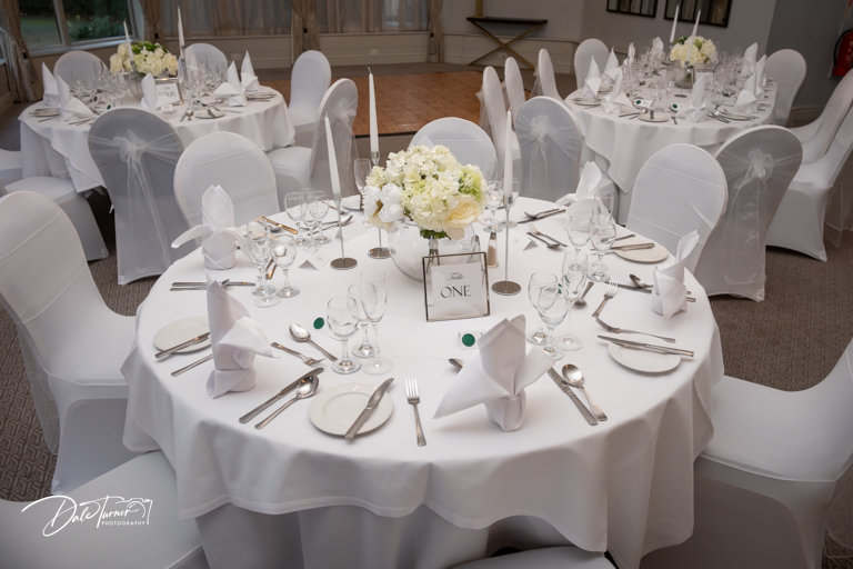 Elegant wedding reception table setup with white decor.