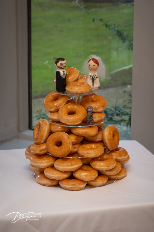 Doughnut wedding cake with bride and groom toppers.