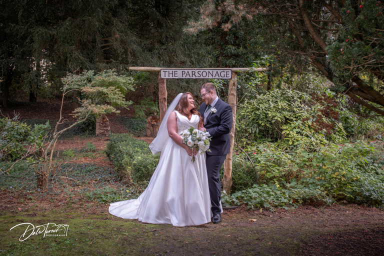 Couple wedding photo with The Parsonage sign.