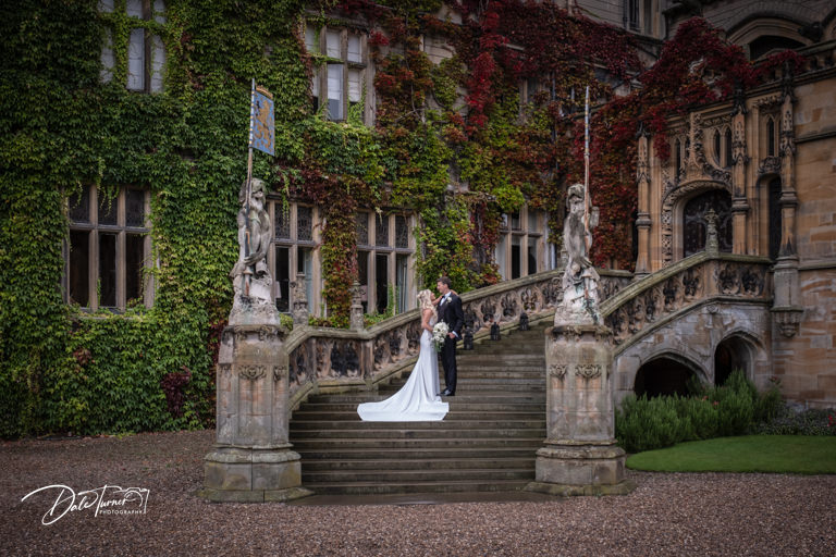 Couple kissing on Carlton Towers steps with ivy.