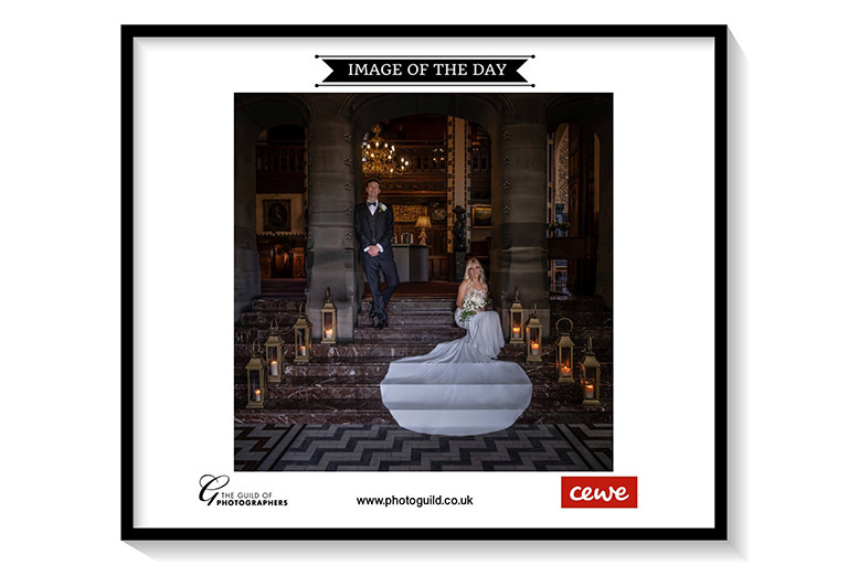 Elegant wedding couple in grand candlelit hall